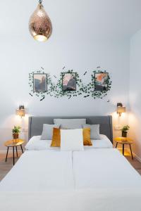 a white bedroom with two beds and two tables at Wonder Mandragora Mátrafüred in Gyöngyös