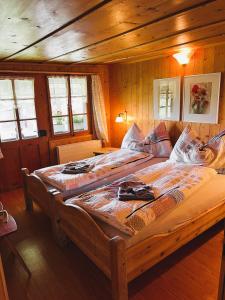 a bedroom with two large beds in a cabin at BnB Haus Itten in Hondrich