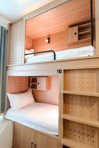 a small room with bunk beds in a caravan at Homix Hotel in Singapore +40 photos