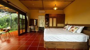 a bedroom with a bed in a room at Yên Retreat & Cafe in Cà Mau
