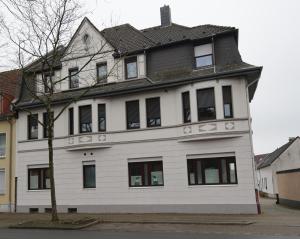 a white house with a gray roof at FeWo Severin in Bottrop