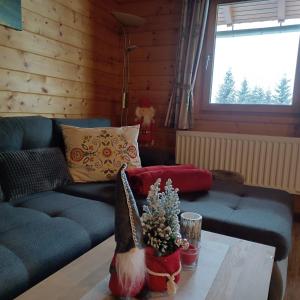 a living room with a couch and a table at Almzeit Klippitz in Klippitztorl