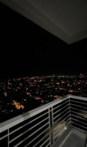 a view of a city at night from a balcony at MERE Suite Davao- One Lakeshore behind SM Lanang in Davao City +2 photos