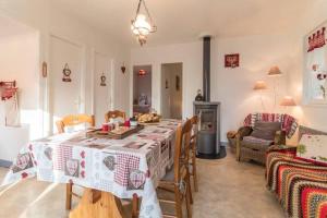 a dining room with a table and chairs and a couch at Il était une fois in Champeau