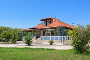 a large house with a red roof at Beachfront Villa Psani - Escape with Garden in Nafpaktos