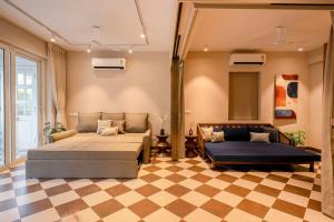 a bedroom with two beds and a checkered floor at Staymaster Solintra A301 - Pool in Nerul +48 photos