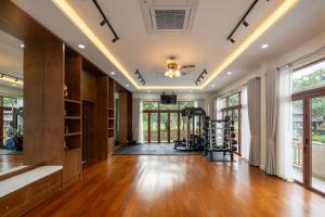an empty living room with wood floors and windows at Spoonamore Villa in Hang Dong