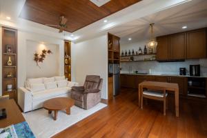 a living room with a white couch and a table at Spoonamore Villa in Hang Dong