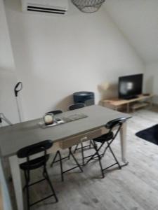 a table and two chairs in a living room at vive l'auvergne in Vensat