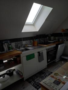 a kitchen with a sink and a skylight at vive l'auvergne in Vensat