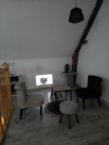 a living room with chairs and a table at vive l'auvergne in Vensat