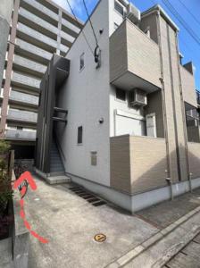 a building with a stairway leading up to it at Le Amo吉塚 in Fukuoka