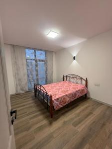 a bedroom with a bed in a room with a window at Garden house for rent2 in Baku