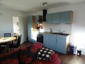 a living room with a couch and a kitchen at Ferienwohnung Schäfer in Waldbreitbach