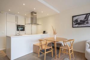 a kitchen and dining room with a table and chairs at Modern Cozy Studio - Prime location Knokke in Knokke-Heist