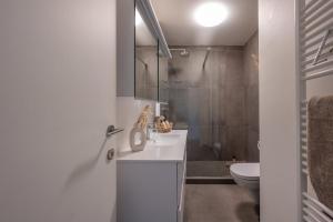 a bathroom with a sink and a shower and a toilet at Modern Cozy Studio - Prime location Knokke in Knokke-Heist