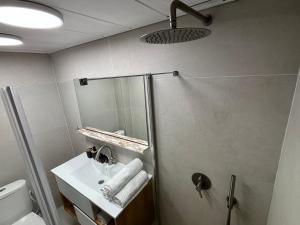 a bathroom with a shower and a sink at Lev Yam Suite in Netanya +3 photos