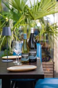 two bottles of wine sitting on a table with glasses at Hotel am Hafen Leverkusen in Leverkusen +27 photos