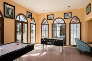 a room with a pool table and windows at Grand Makadi - Couples and Families Only in Hurghada