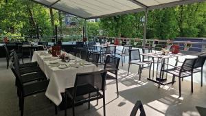 a group of tables and chairs sitting on a patio at Hotel Restaurant Passmann in Lüdenscheid