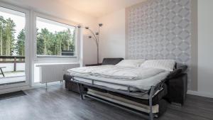 a bedroom with a bed in front of a window at Golfresidenz B 106 in Grömitz +27 photos