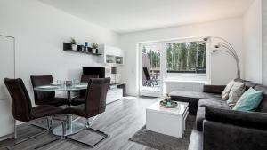 a living room with a couch and a table at Golfresidenz B 106 in Grömitz