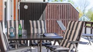 a table and chairs on a patio with a drink at Golfresidenz B 106 in Grömitz