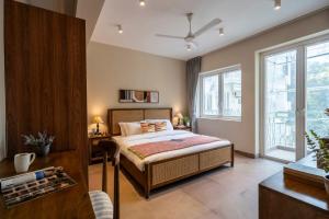 a bedroom with a bed and a window at Staymaster Solintra C301 - Pool in Nerul +78 photos