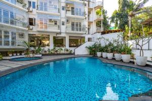 a swimming pool in front of a building at Staymaster Solintra C301 - Pool in Nerul