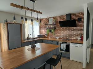 a kitchen with a wooden counter and a brick wall at Porte de secours in Albertville