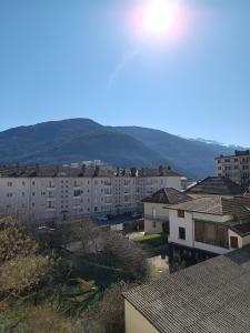 a city with buildings and mountains in the background at Porte de secours in Albertville