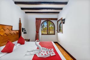 a bedroom with a bed with two swans on it at Grand Makadi - Couples and Families Only in Hurghada +51 photos