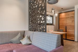 a living room with a couch and a table at Corso Living in Sölden