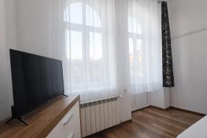a living room with a flat screen tv next to a window at Apartament Panorama Centrum in Przemyśl