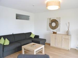 a living room with a couch and a table at Golfresidenz D 1 03 in Grömitz
