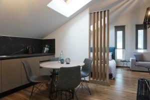 a kitchen and living room with a table and chairs at Athenean Rooftop Nest in Athens