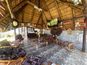 a living room with chairs and a flat screen tv at Martinique Guesthouse in Kathu