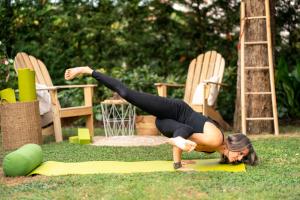 a woman doing a push up in the grass at Residence Bianca in Sirmione