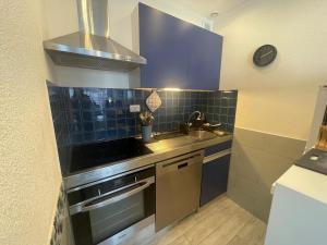 a kitchen with a sink and a stove top oven at Appartement - Bonamour in Capbreton +1 photo