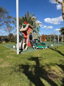 a shadow of a person in front of a playground at Sea view apartments in Caesarea