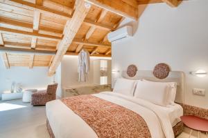 a bedroom with a large bed and wooden ceilings at Nalia Suites in Nafplio