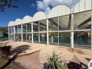 a large glass building with a swimming pool at Sea view apartments in Caesarea