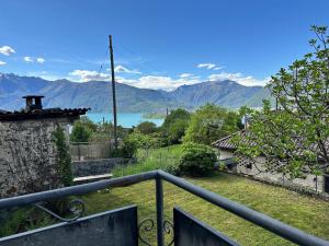 a balcony with a view of a lake and mountains at Ferienhaus in Piazzogna in Gambarogno
