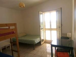 a small room with a bed and a window at Camera singola in affitto con bagno privato interno in Montenero di Bisaccia