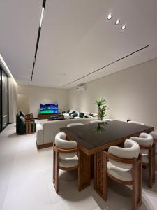 a living room with a table and a couch at شاليه جازلي in Riyadh