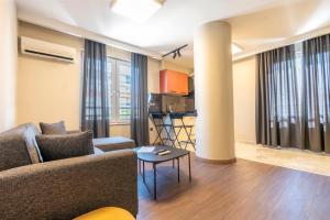 a living room with a couch and a table at Premium Rezidans Otel in Antalya