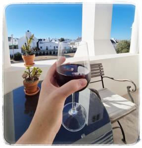 a person holding a glass of red wine at Ciao in Paternoster +45 photos