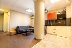 a living room with a couch and a table at Premium Rezidans Otel in Antalya +30 photos