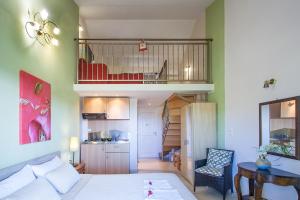 a living room with a bed and a balcony at Syrainas studios in Troulos