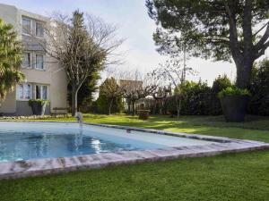 a swimming pool in the yard of a house at ibis Arles in Arles